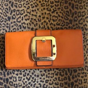 Michael Kors leather clutch with large gold buckle